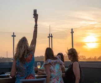 Enjoy drinks on the rooftop at Caribsea on your fall girls getaway to Emerald Isle