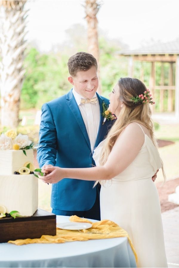 Couple cutting wedding cake at Emerald Isle wedding