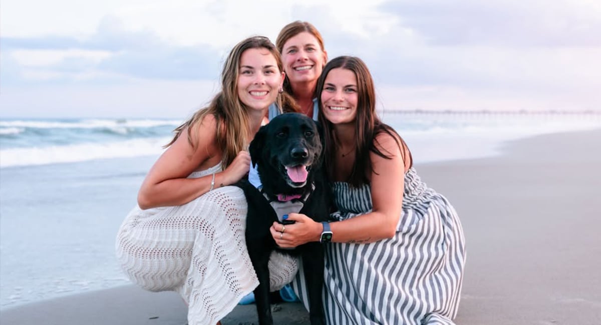 family on a beach vacation with their dog