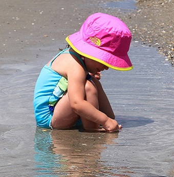 Girl playing on beach in Emerald Isle NC